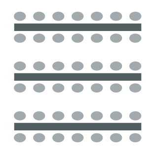 Three rows of tables with seating on both sides. 