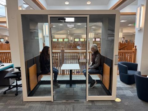 Picture of 2 people sitting in mezzanine meeting room pod.